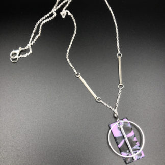 purple and black rectangle with silver circle and bar charm